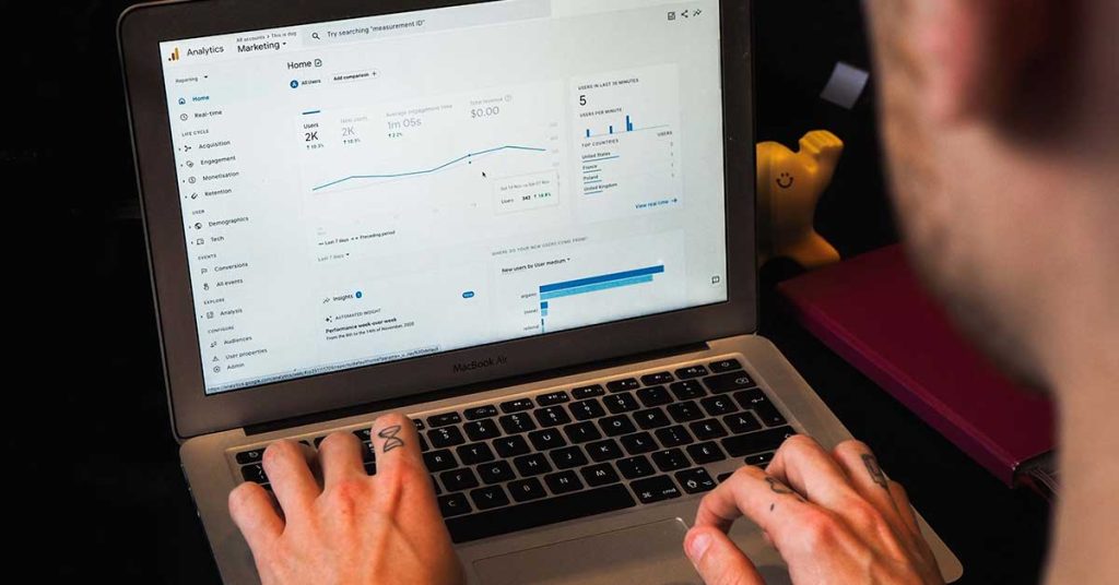 Image of hands on a. laptop keyboard for the blog post: 7 Proven Strategies: Unlock the Power of Google Analytics Website Traffic to Skyrocket Your Cincinnati Business