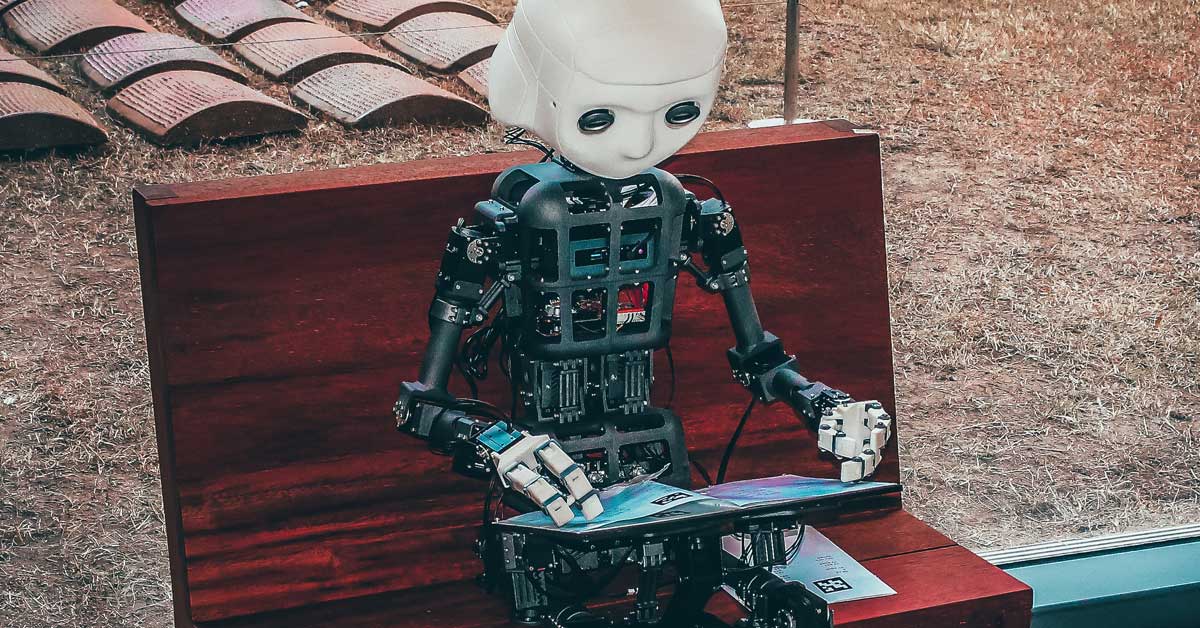 Robot artificial intelligence reading book in park